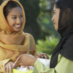 Two young muslim women talking outdoors